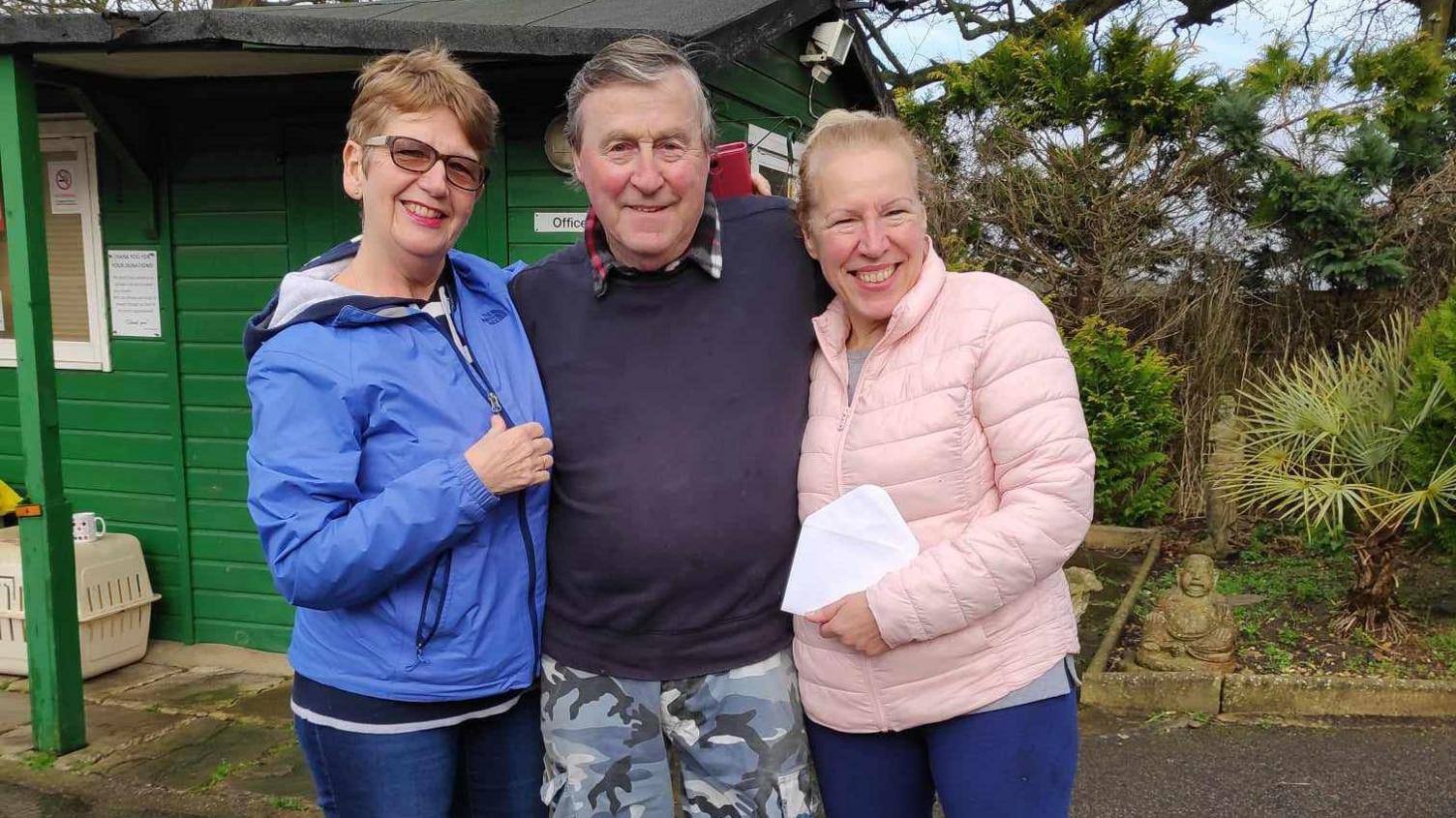 Brian Johnson with two women standing outside the centre