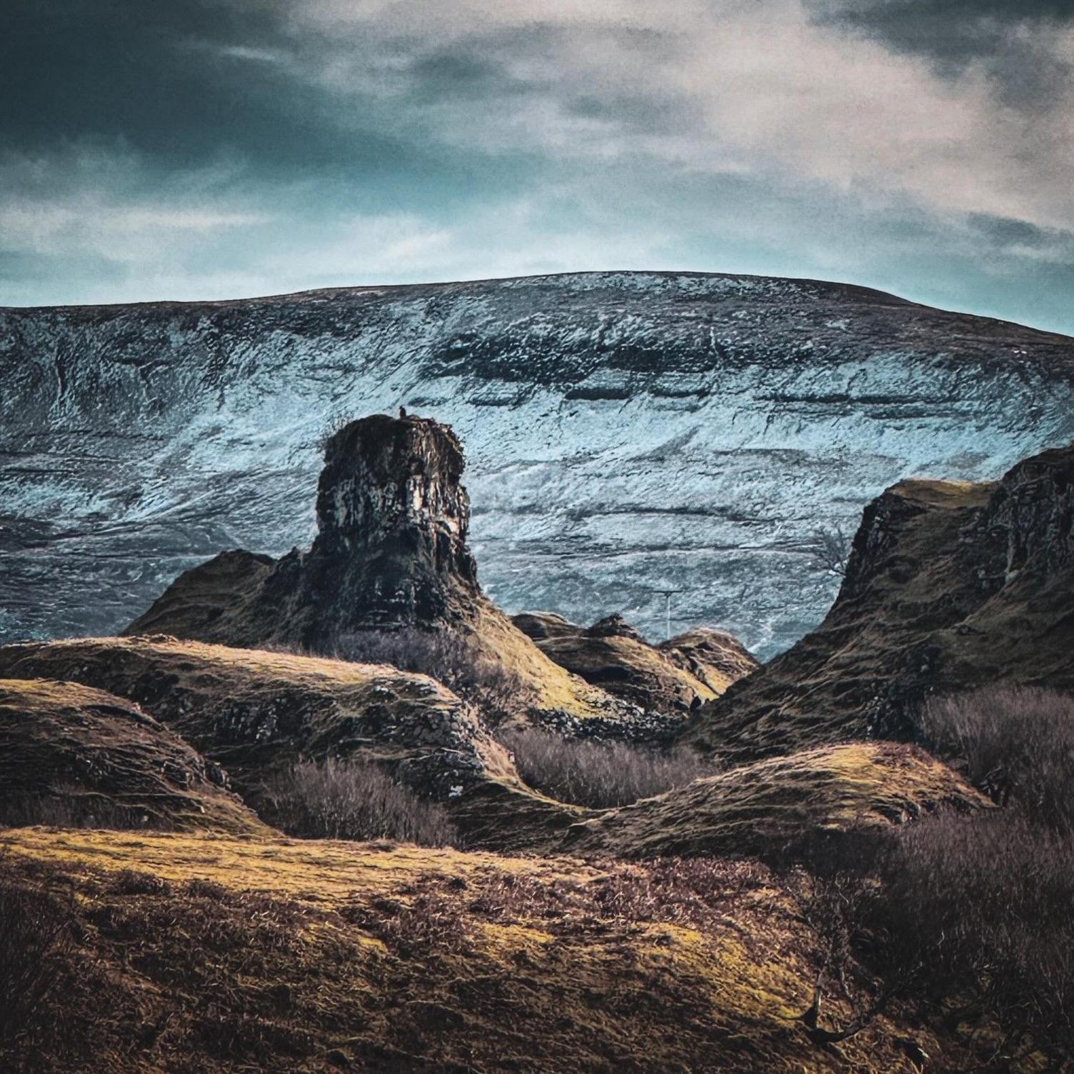 A dark shot of a mountainous landscape.