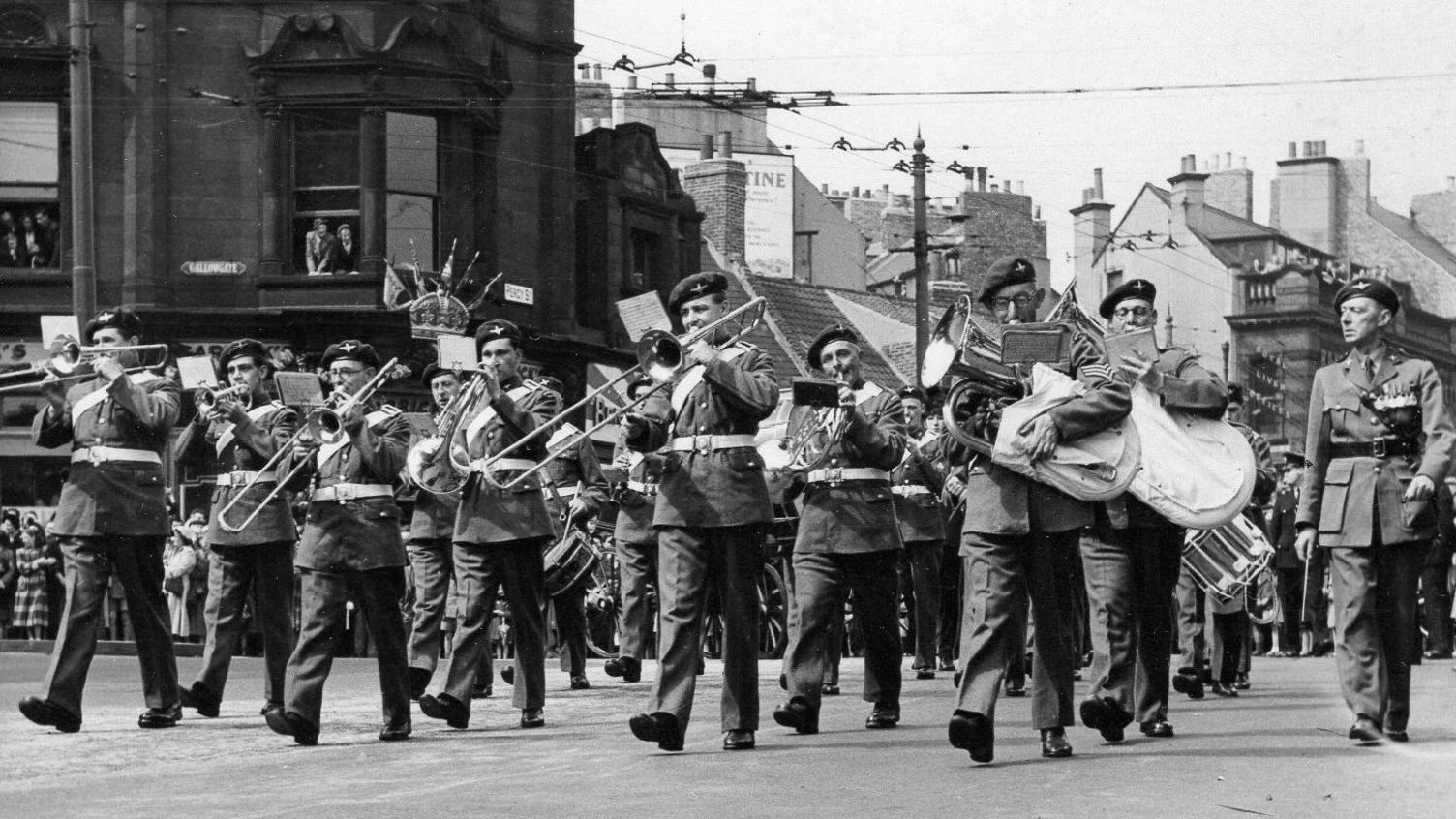 A black and white image of a marching band.