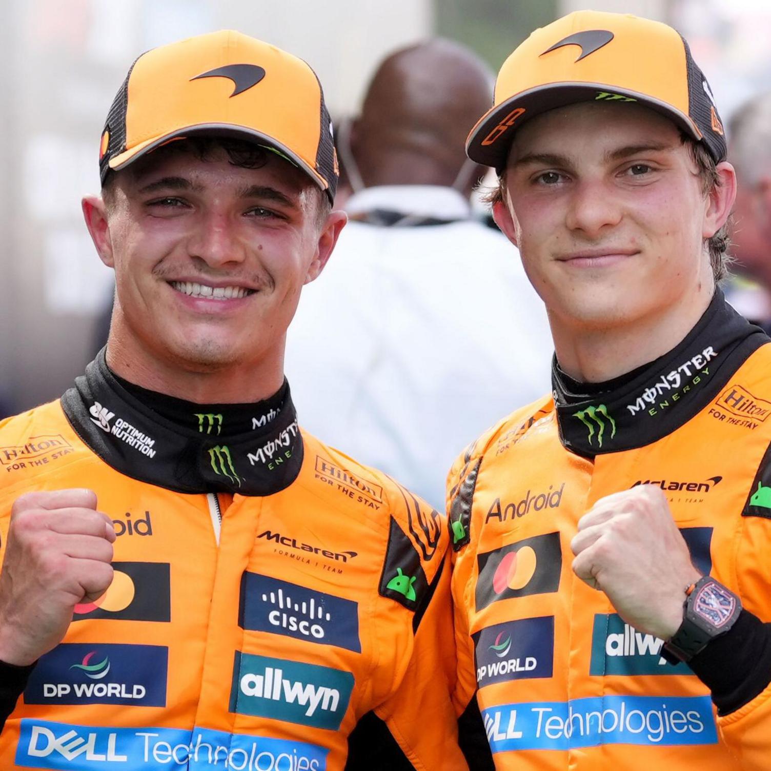 Lando Norris and Oscar Piastri clench their fists in celebration after finishing one-two, with Piastri winning, in this year's Spanish Grand Prix