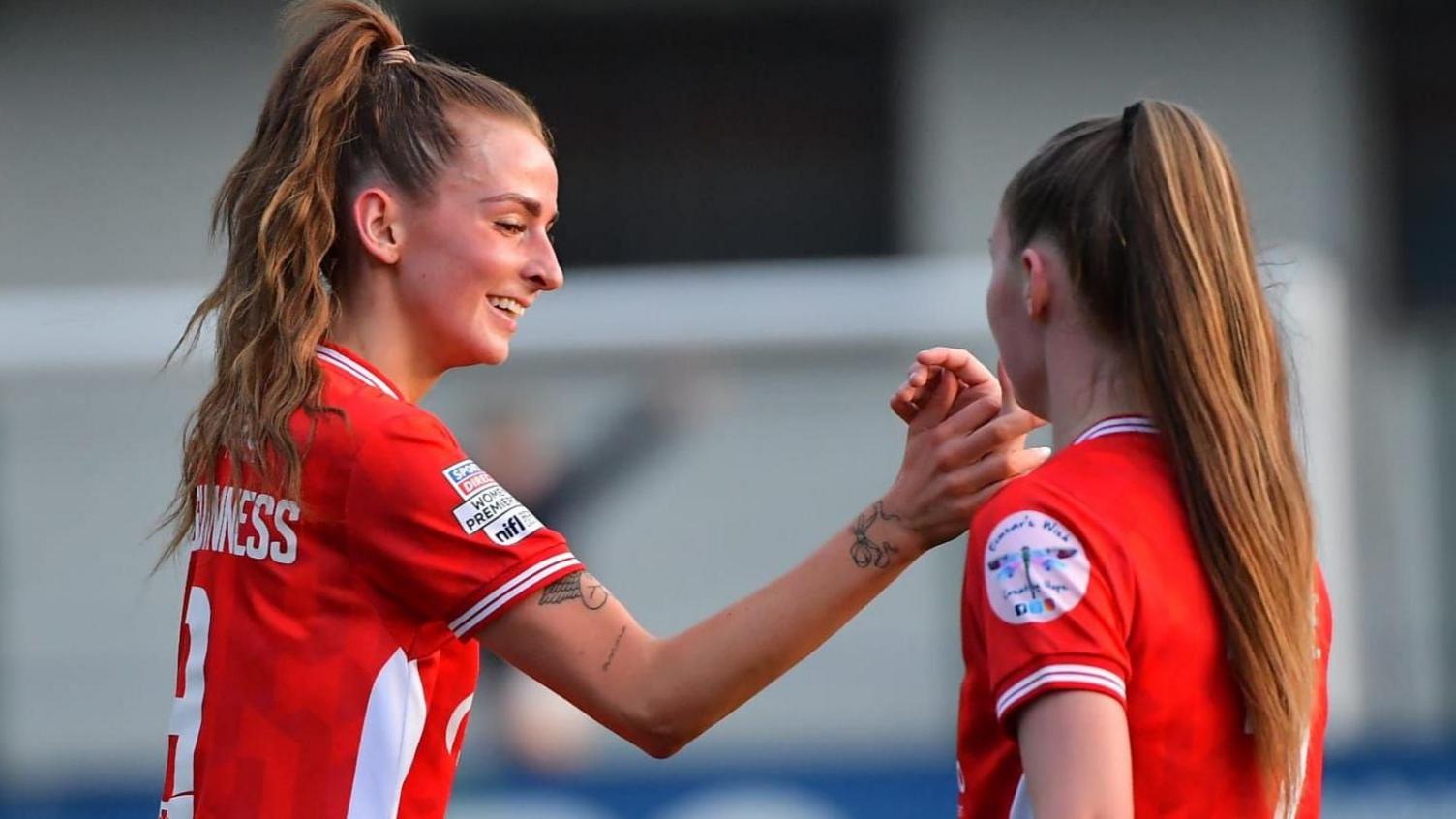 Caitlin McGuinness is congratulated after scoring Cliftonville's first goal against Glentoran