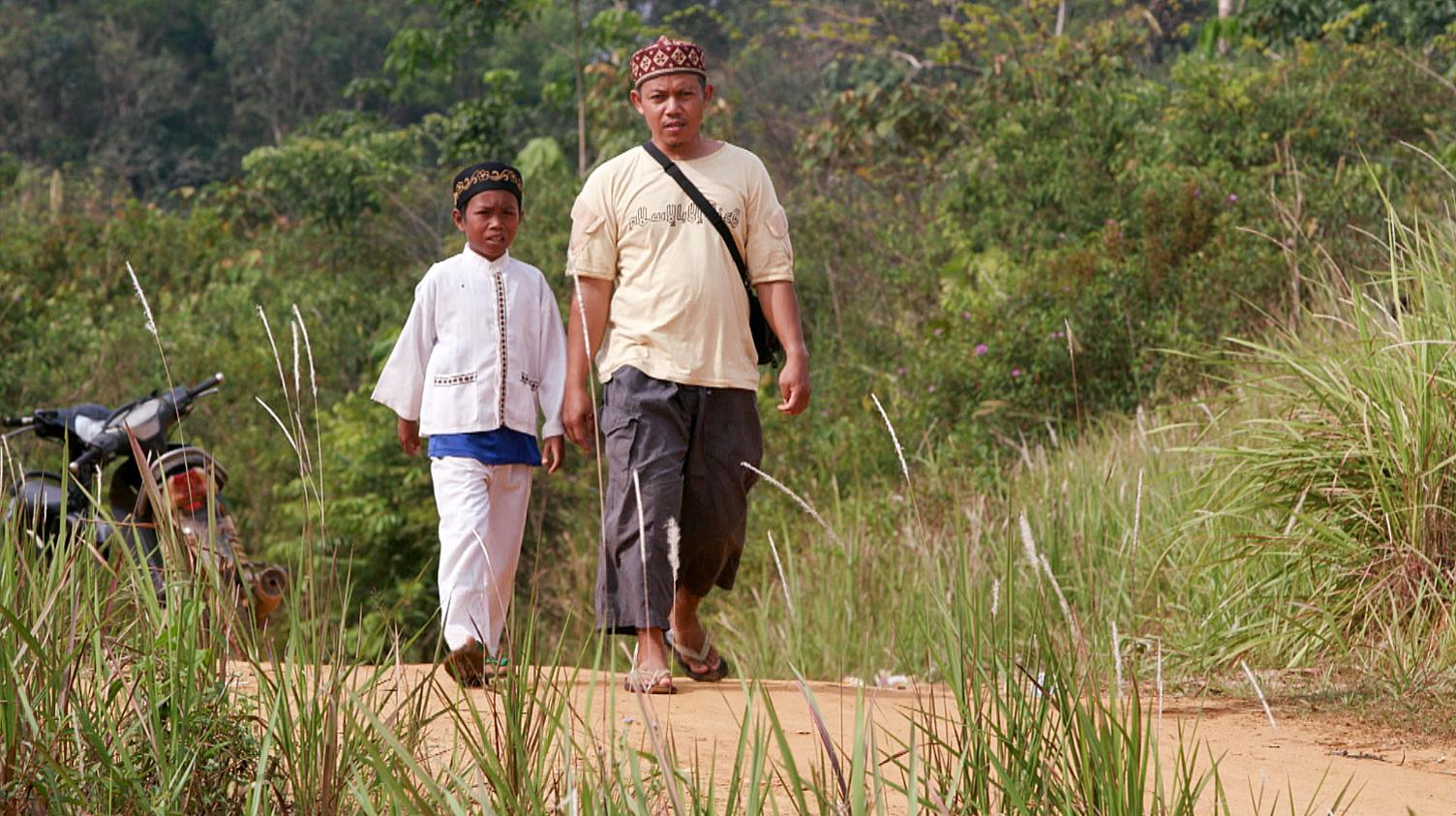 Missionary Ustad Reyhan (right) with a young Muslim boy