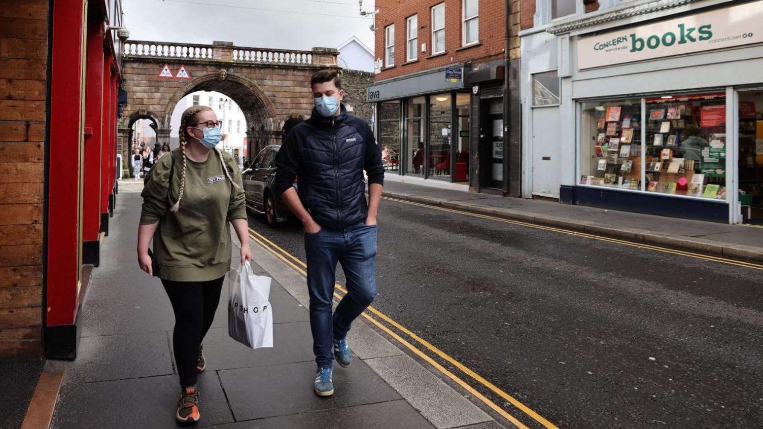 Two young people wearing masks in Derry