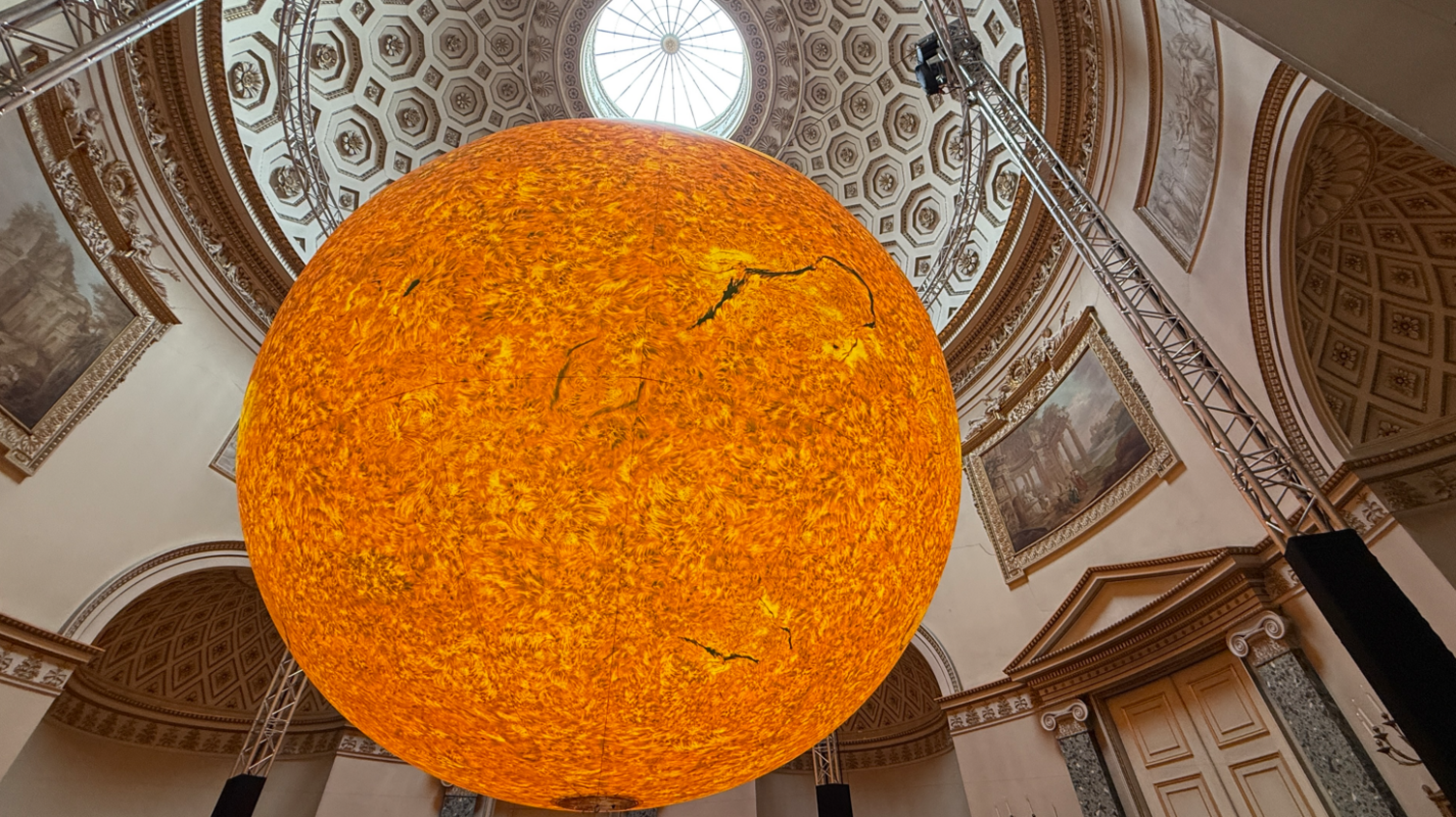 Illuminated sun sculpture hung up inside Kedleston Hall