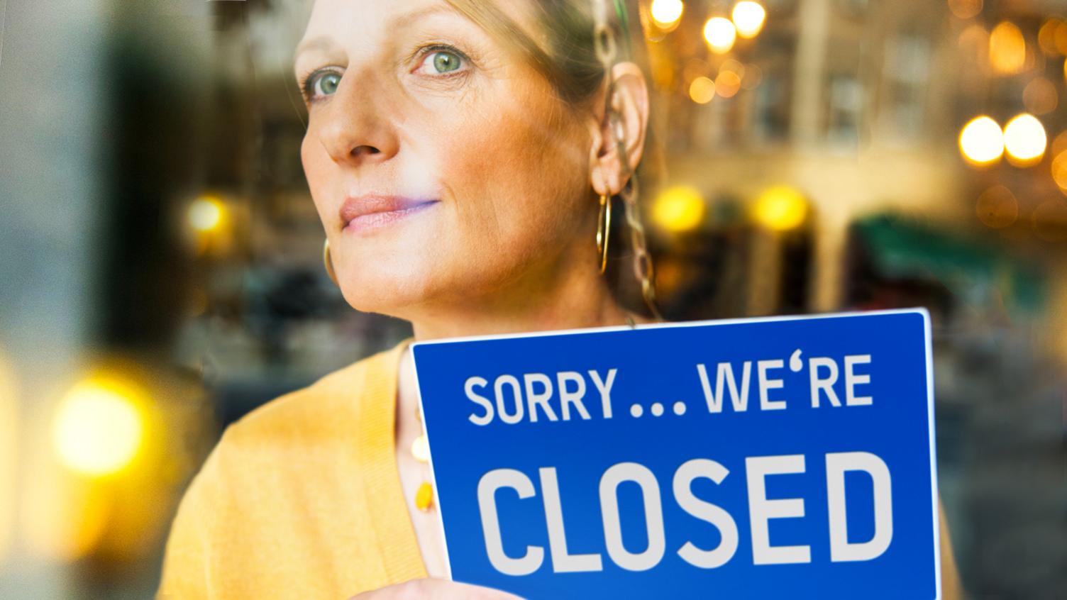 Woman with shop sign