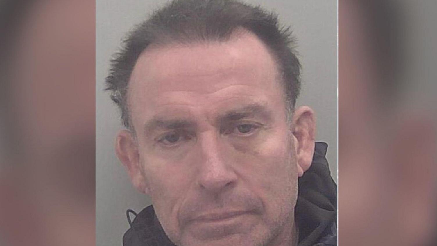 A police mugshot of David Buisson