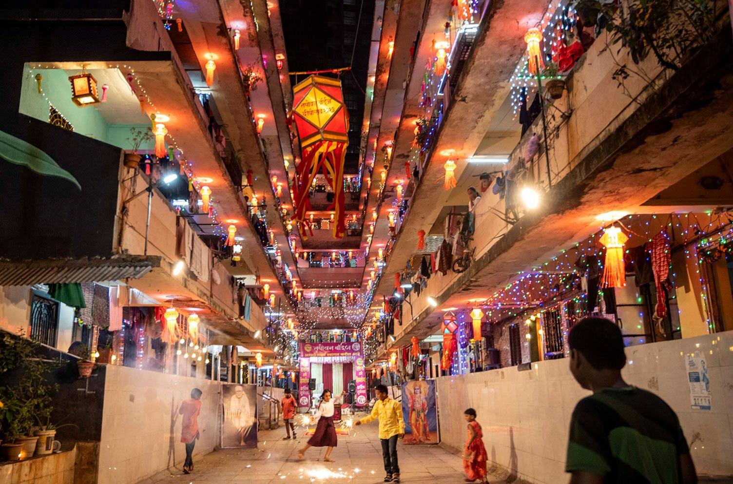 Rows of apartments lit up with electric lights and lamps in a housing complex in Mumbai's Parel