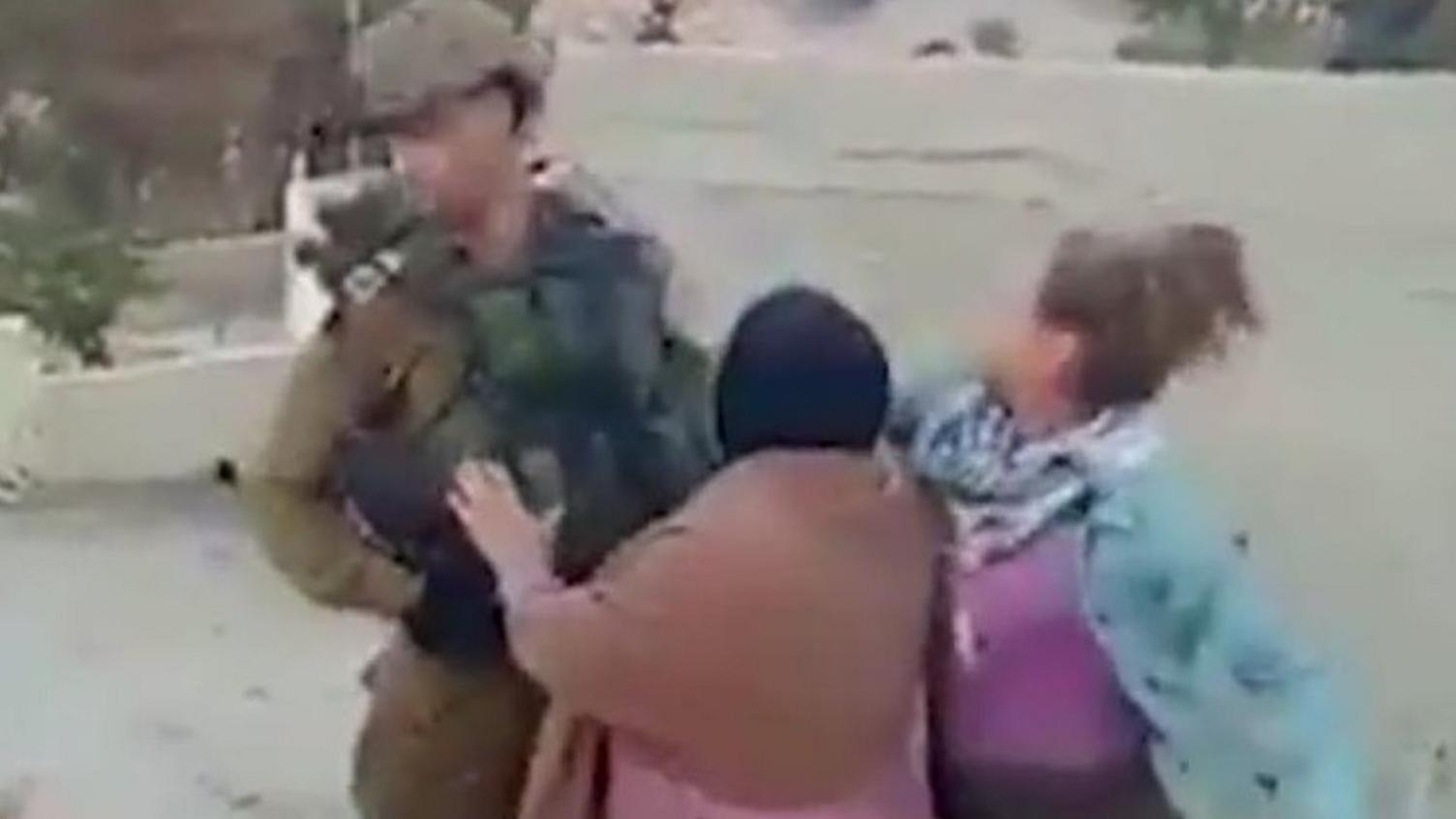 Screengrab of a video showing a Palestinian girl appear to strike an Israeli soldier in the West Bank village of Nabi Salih on 15 December 2017