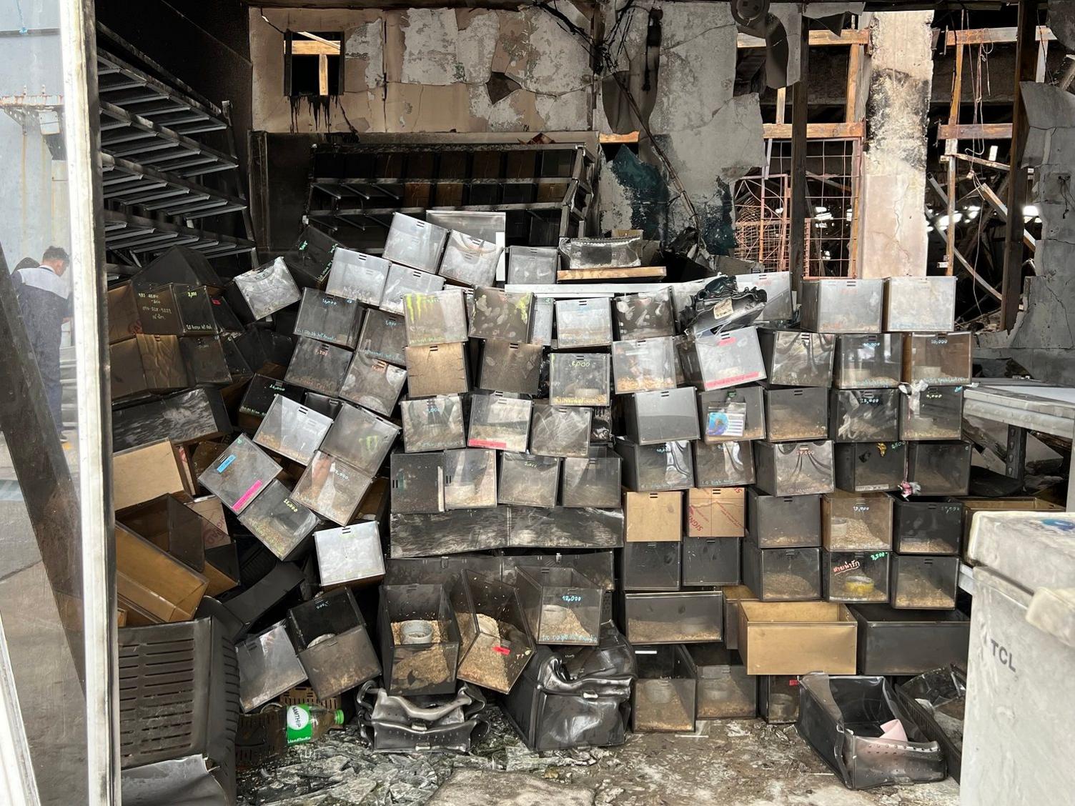 A pile of boxes that housed snakes in one of the shops damaged by the fire in the market