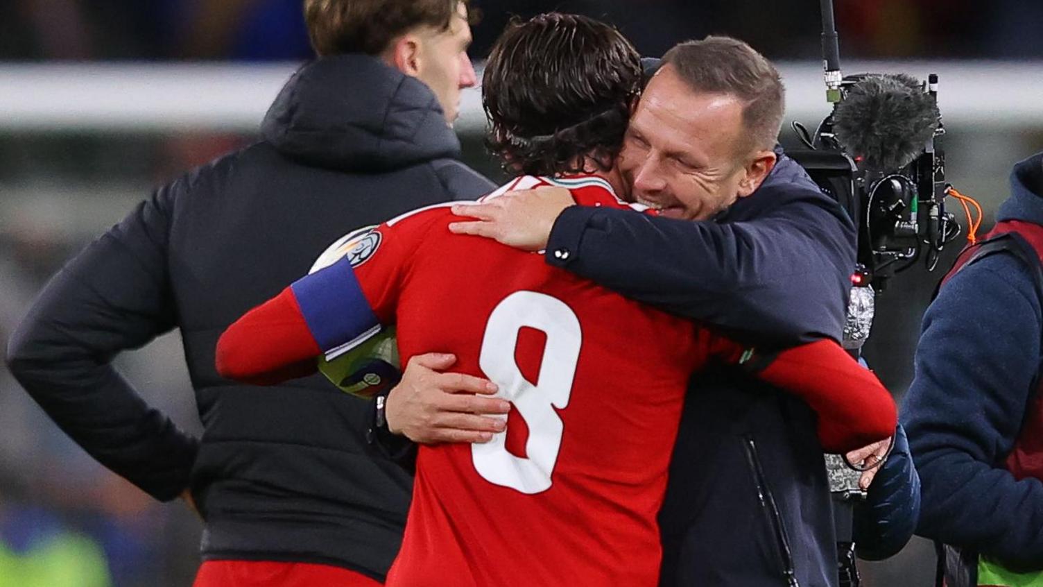 Craig Bellamy (right) hugs Harry Wilson after Wales thrash North Macedonia 7-1 in November 2025