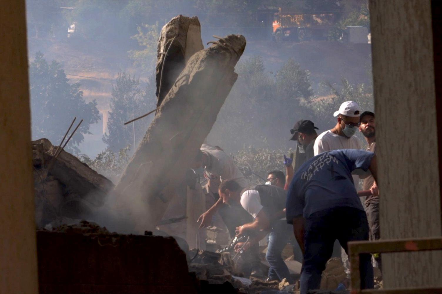 Samir and his crew look for bodies in the rubble.