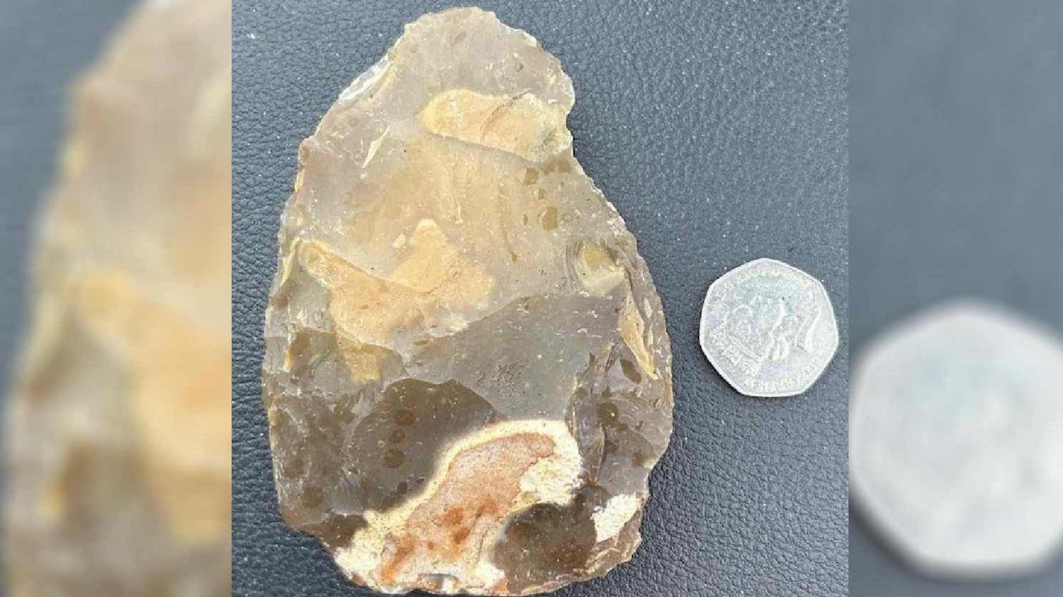 The hand axe with a 50p for size comparison