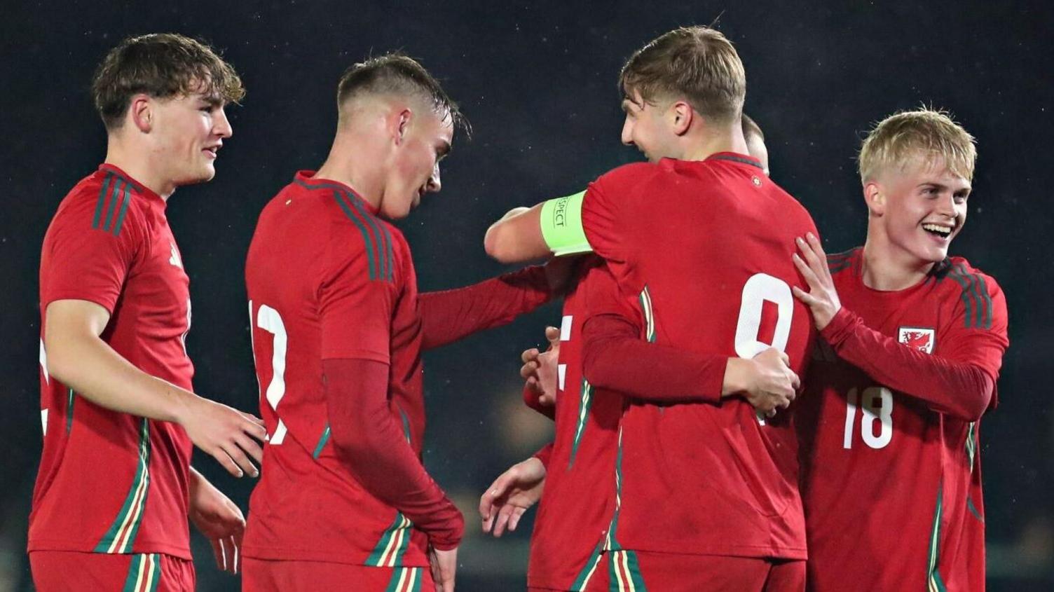 Wales players celebrate a goal against Japan