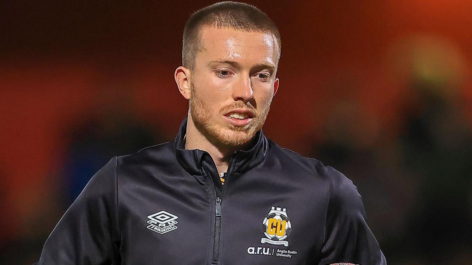 A young Louis Chadwick in a black Cambridge United tracksuit top
