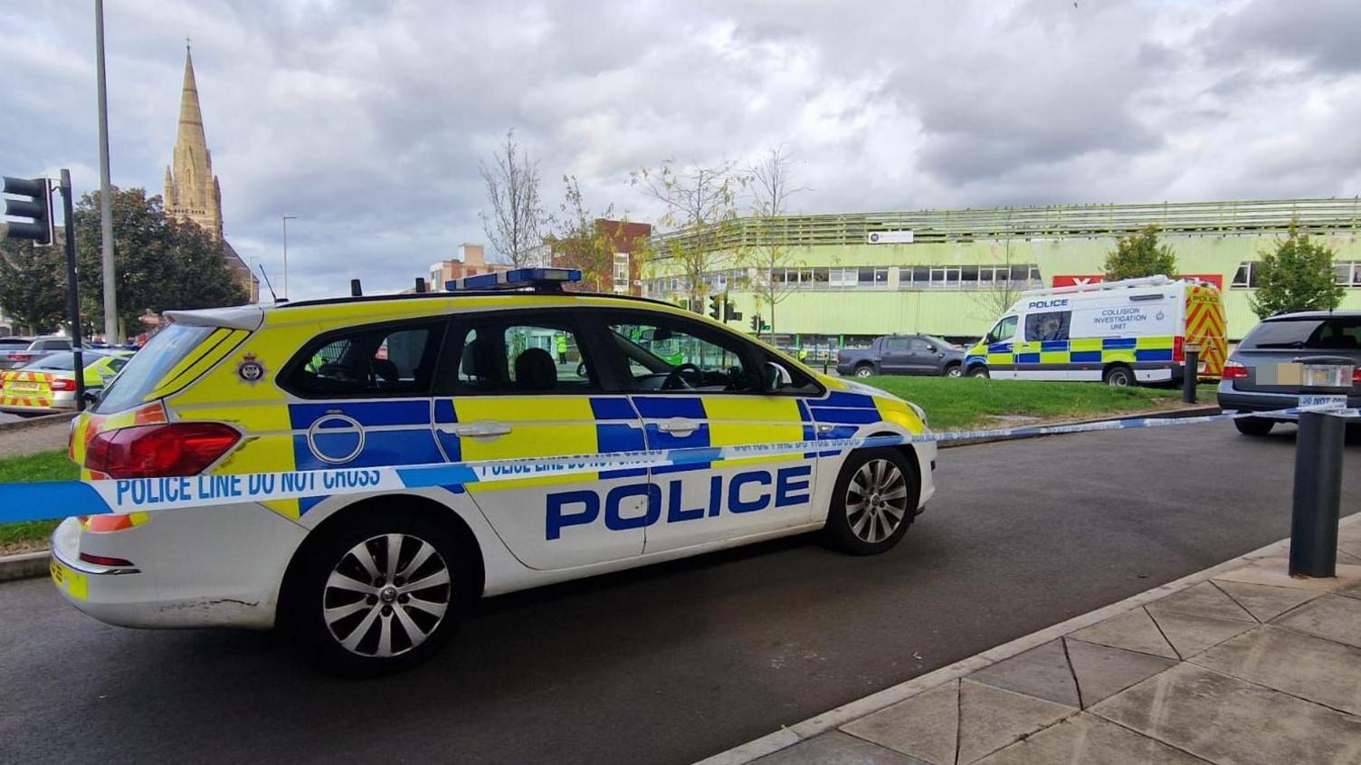 Multiple police cars and a police cordon
