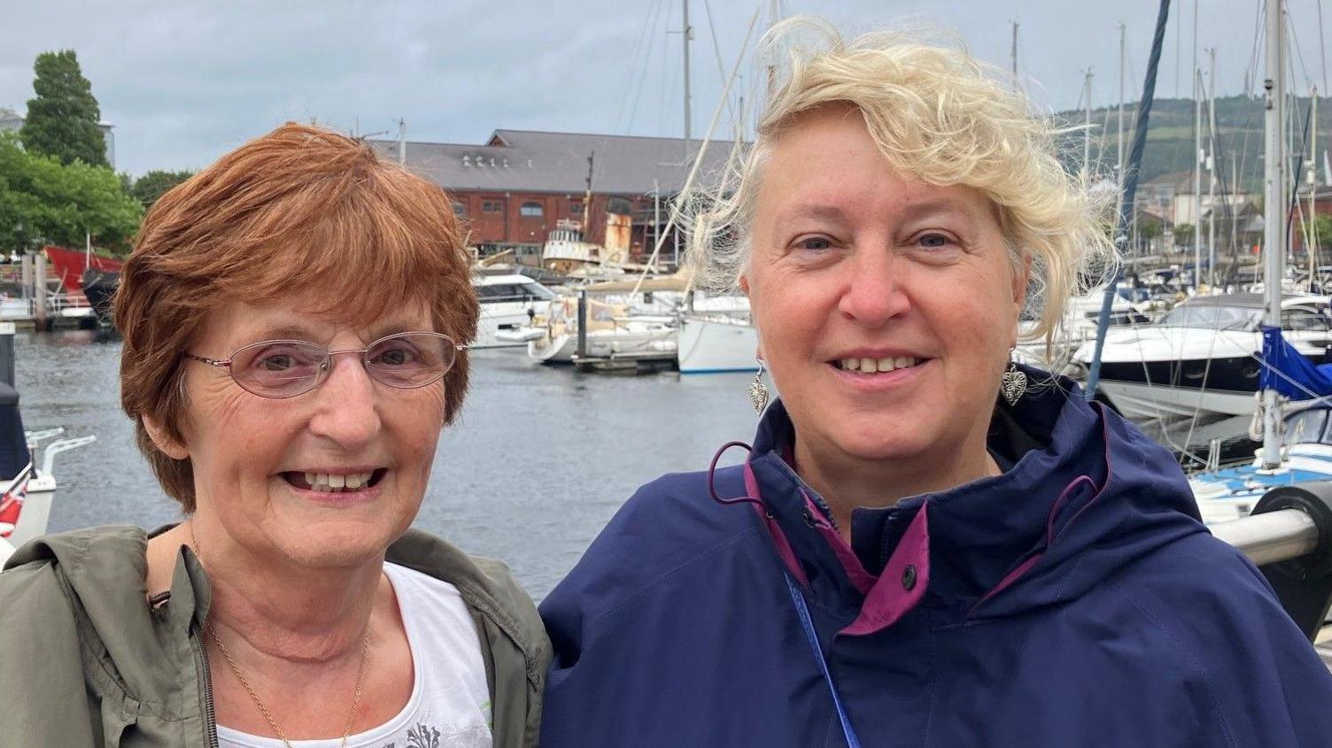 A picture of Margaret and Anne with boats in the background