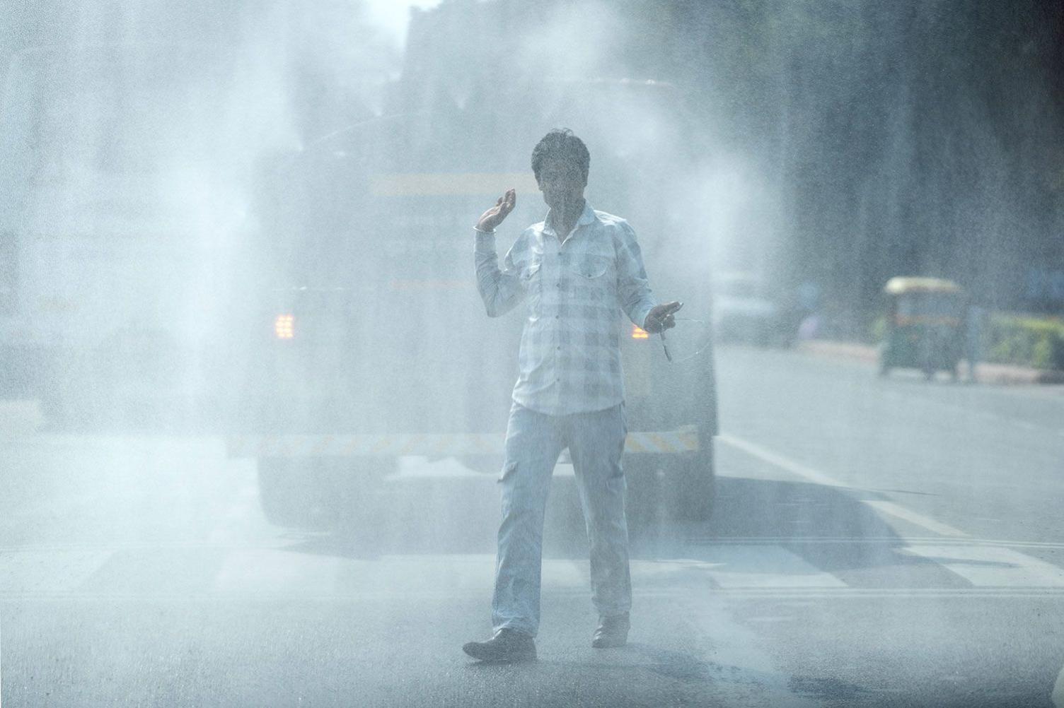 A vehicle sprays water onto the road for dust suppression in New Delhi, India, on Tuesday