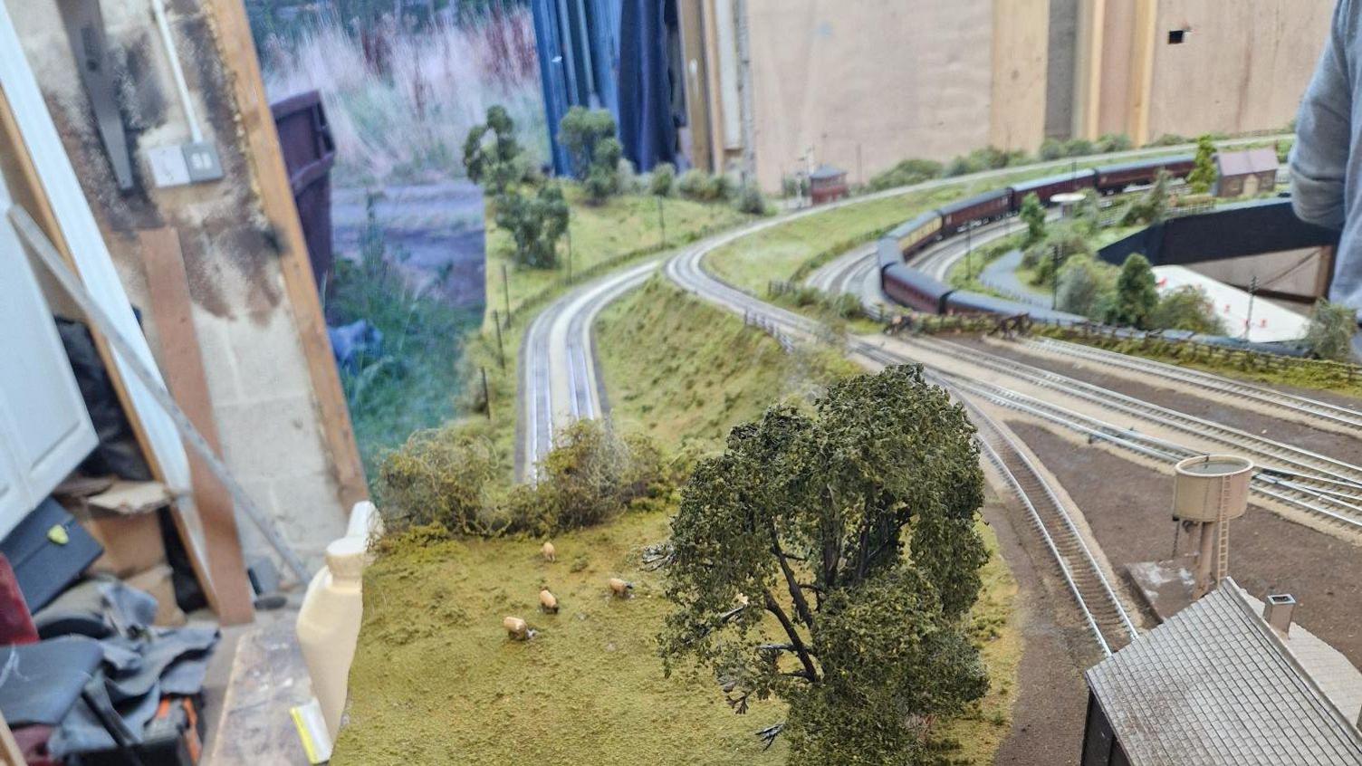 Model railway scenery including miniature sheep, grass and trees 