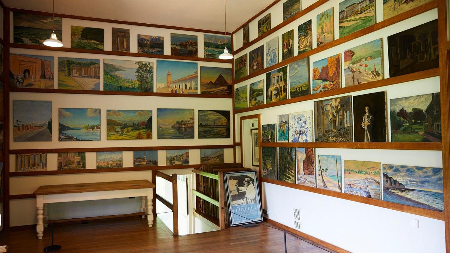 A series of paintings hanging on the wall of Chartwell.