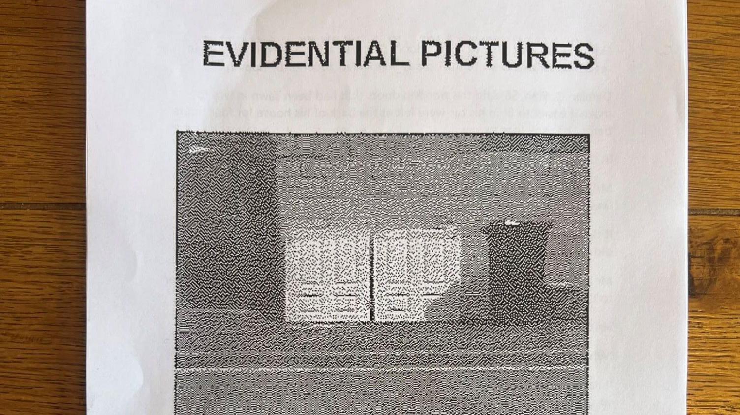 A piece of A4 paper with an image of the doors cut in half and resting against a wall next to a bin. There is writing which says evidential pictures above the image.