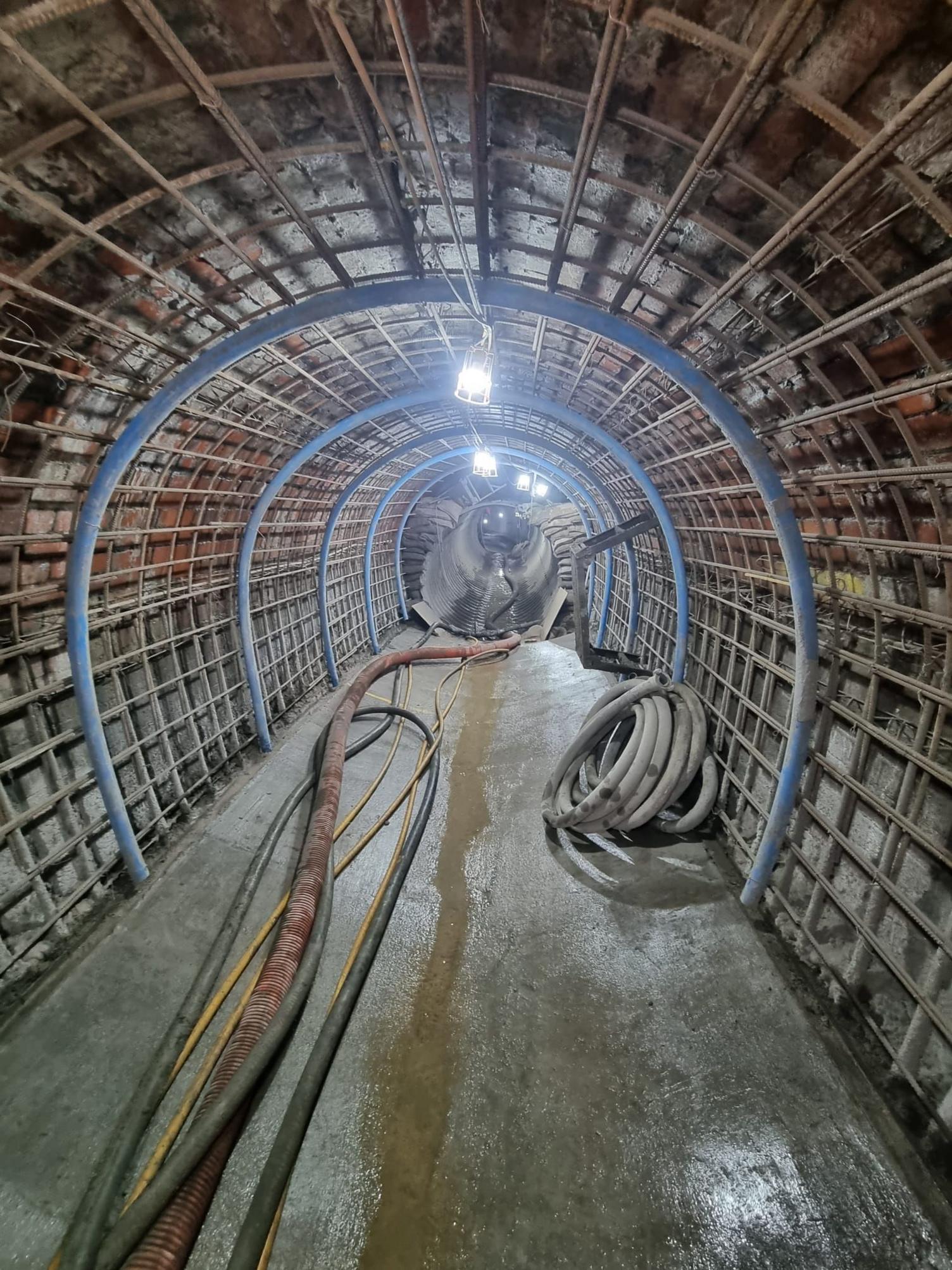 A pump runs through the inside of the new culvert made of concrete and steel and lit by lamps. 