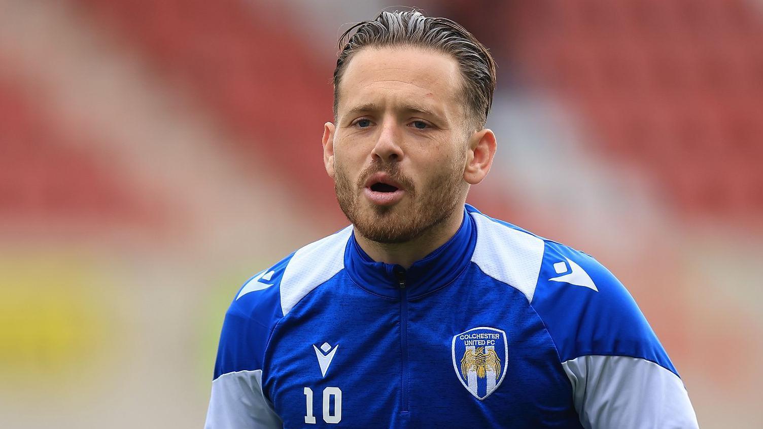 Close-up image of Colchester United's Jack Payne warming up before a game