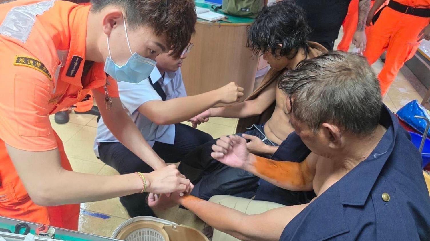 Coast guard staff tending to the survivors' injuries