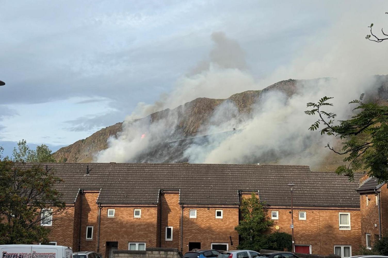 Fire on hill with terraced housing in the foreground