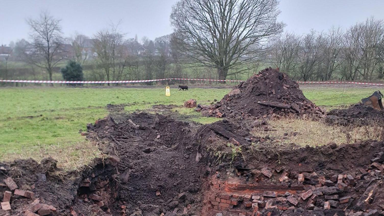 Exposed brickwork after an area of a field has been dug up 