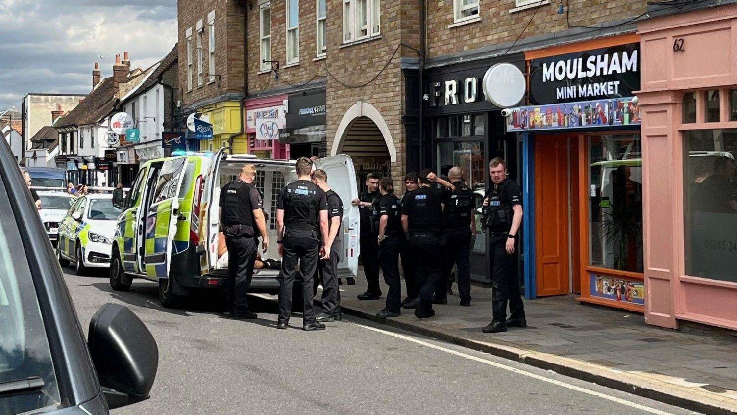 Police officers surrounding a van in Moulsham Street, Chelmsford