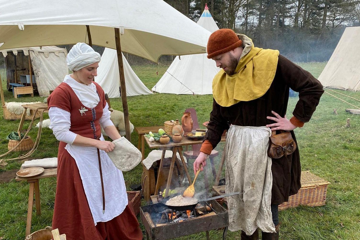 Medieval cooking demonstrations in an encampment