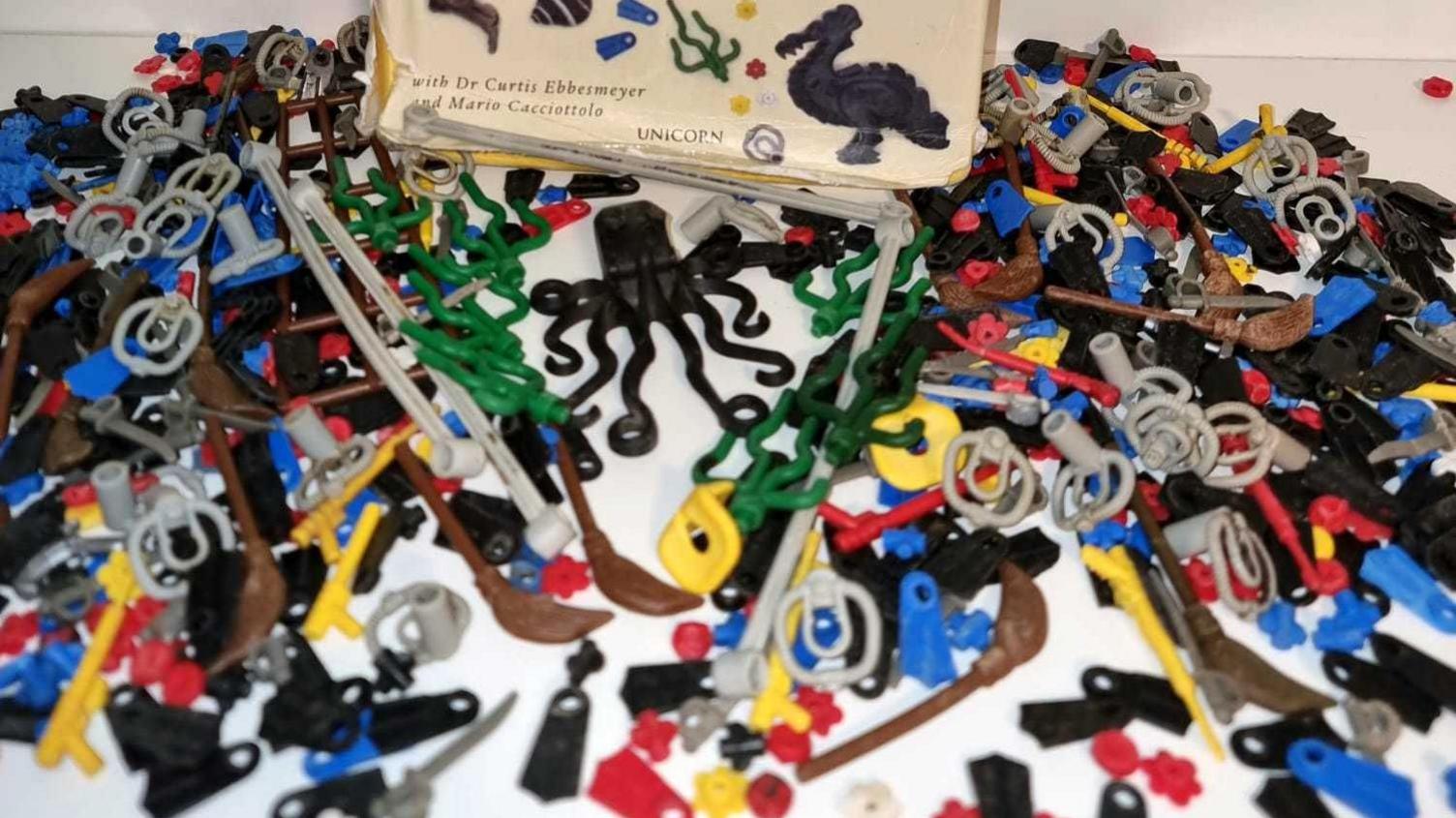 The collection of Lego Liutauras has found, lying in front of a book about the Lego Lost at Sea project called Adrift. There is a black octopus, flippers, witches' brooms, divers' breathing apparatus, seaweed and spear guns.