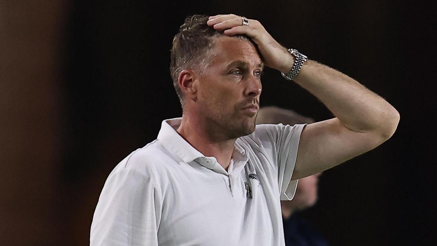Rob Edwards watching his Middlesbrough team lose to Doncaster with his left hand on his head looking forlorn