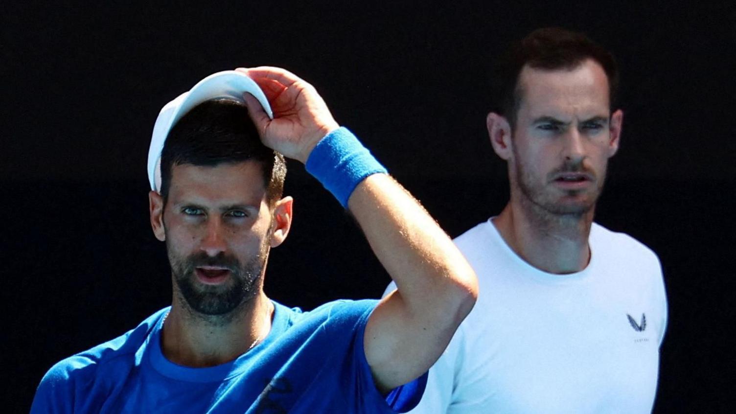 Andy Murray watches Novak Djokovic in practice