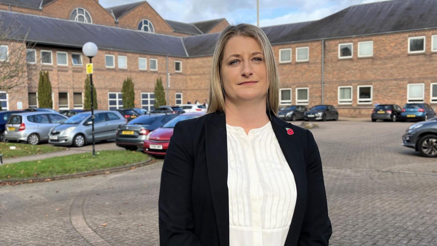 Det Insp Alix Wright stood outside Norwich Crown Court. She has blonde hair and is wearing a black suit jacket and white top.