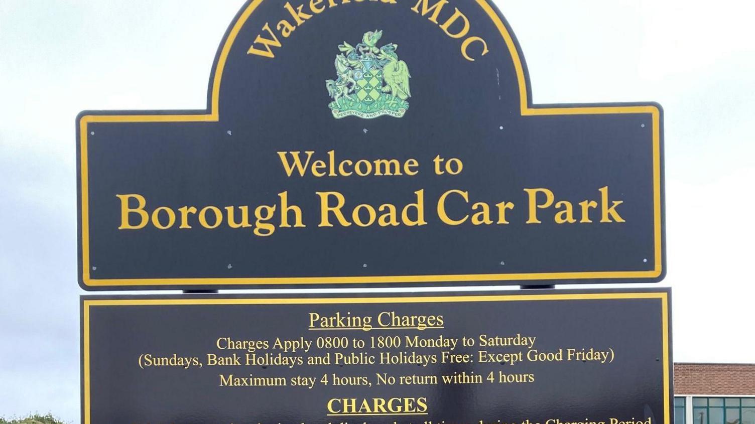 A sign indicating Borough Road Car Park in Wakefield. Information about parking charges and maximum stay times is included beneath the 'welcome' sign.