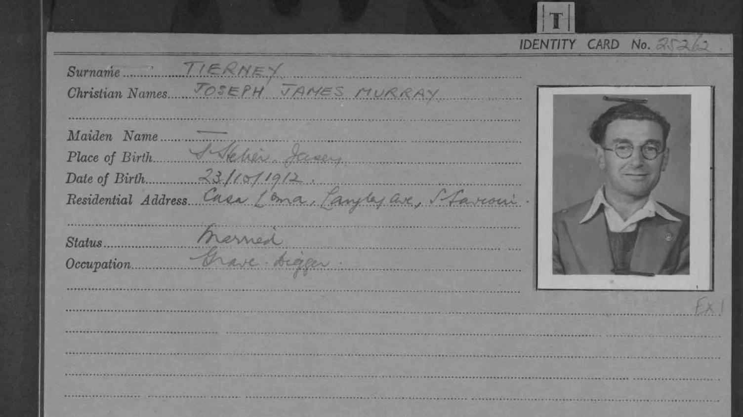A picture of an old identity card. To the right of the card is a black and white image of Joseph Tierney, his name and other details are written to the left of the image. 