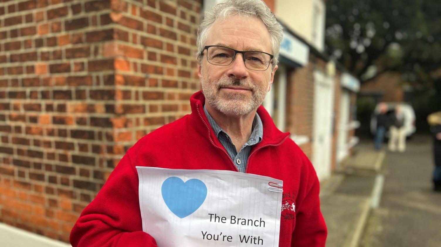 David Silver holding a sign