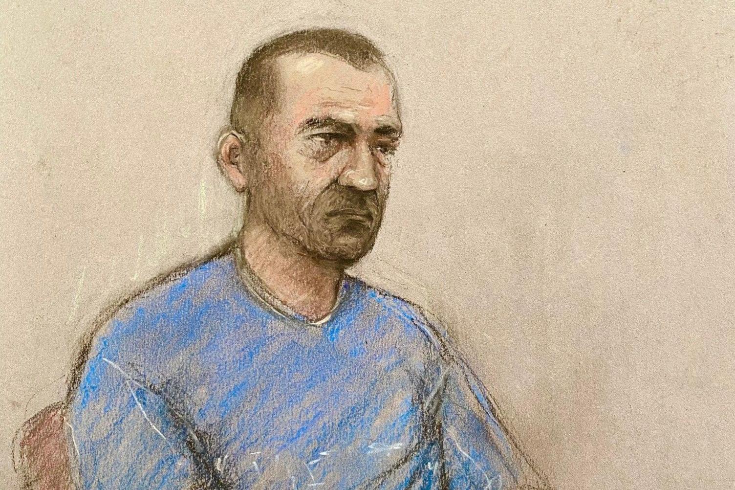 A sketch of David Carrick in court, wearing a blue T-shirt, unshaven and with a short buzz cut.