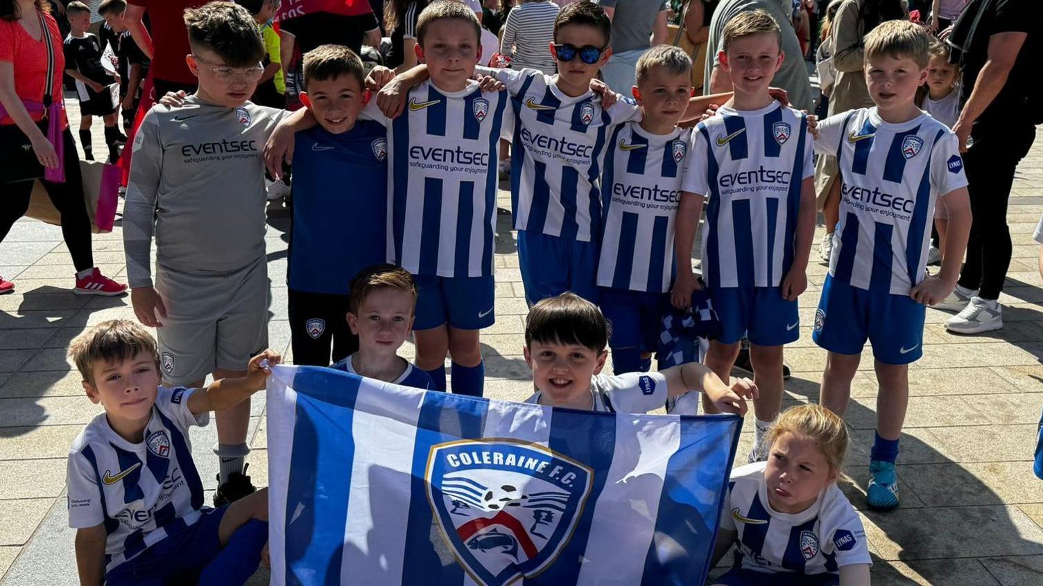 Shows children dressed in the Coleraine FC kit