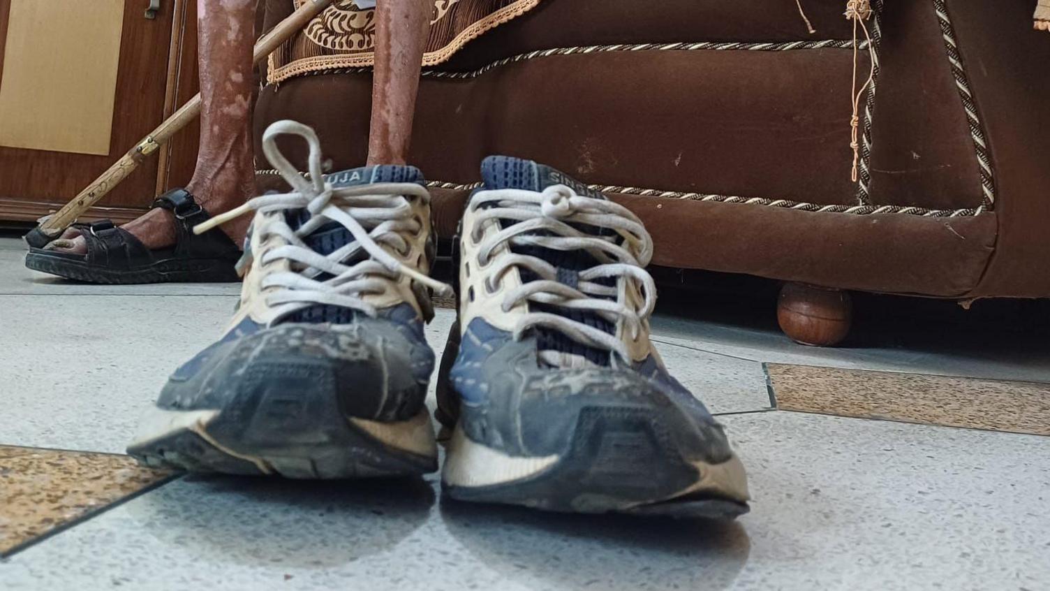 Pictured Singh's blue and white running shoes covered, worn out from use