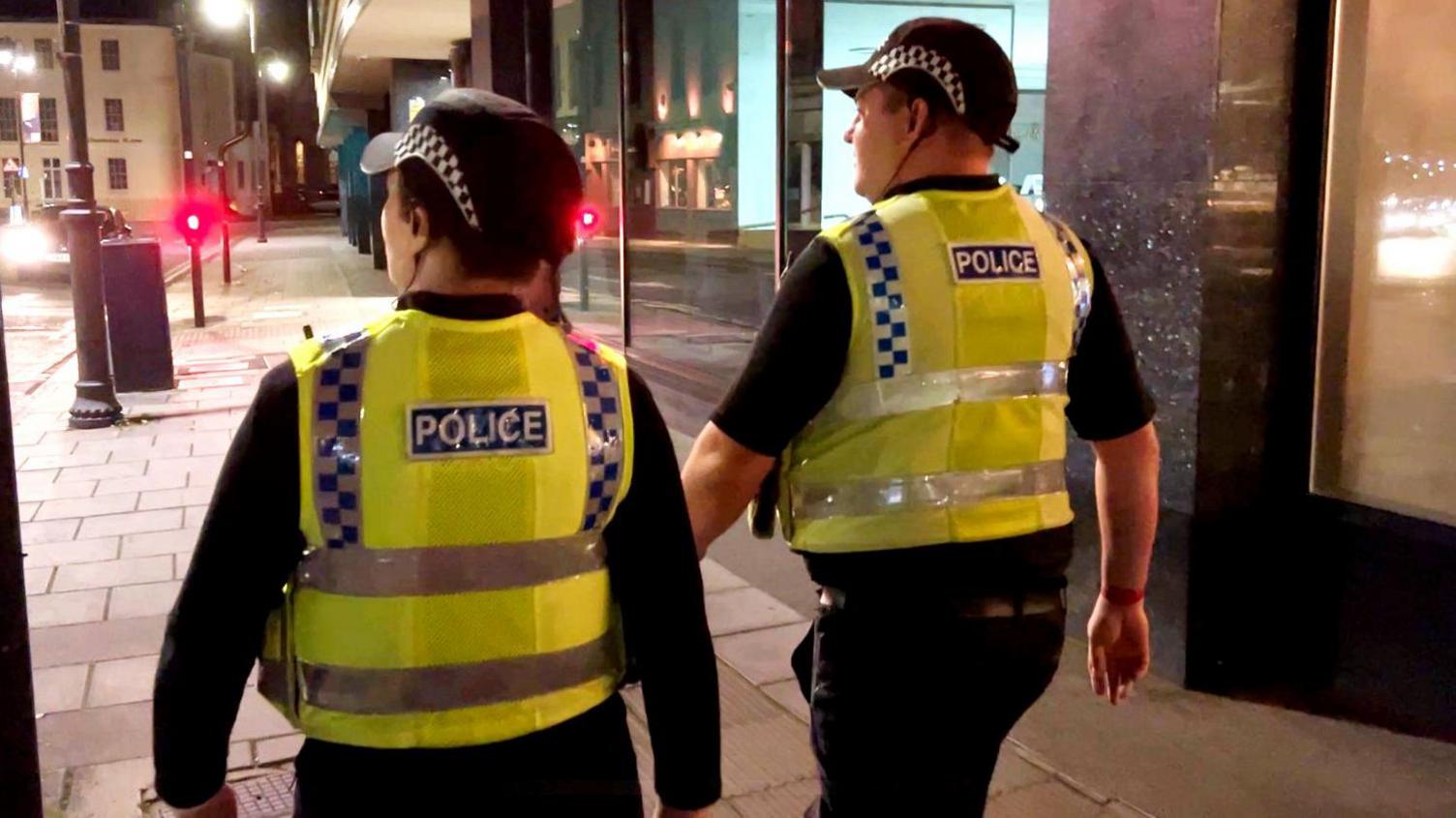 Police officers in uniform walking around Cheltenham