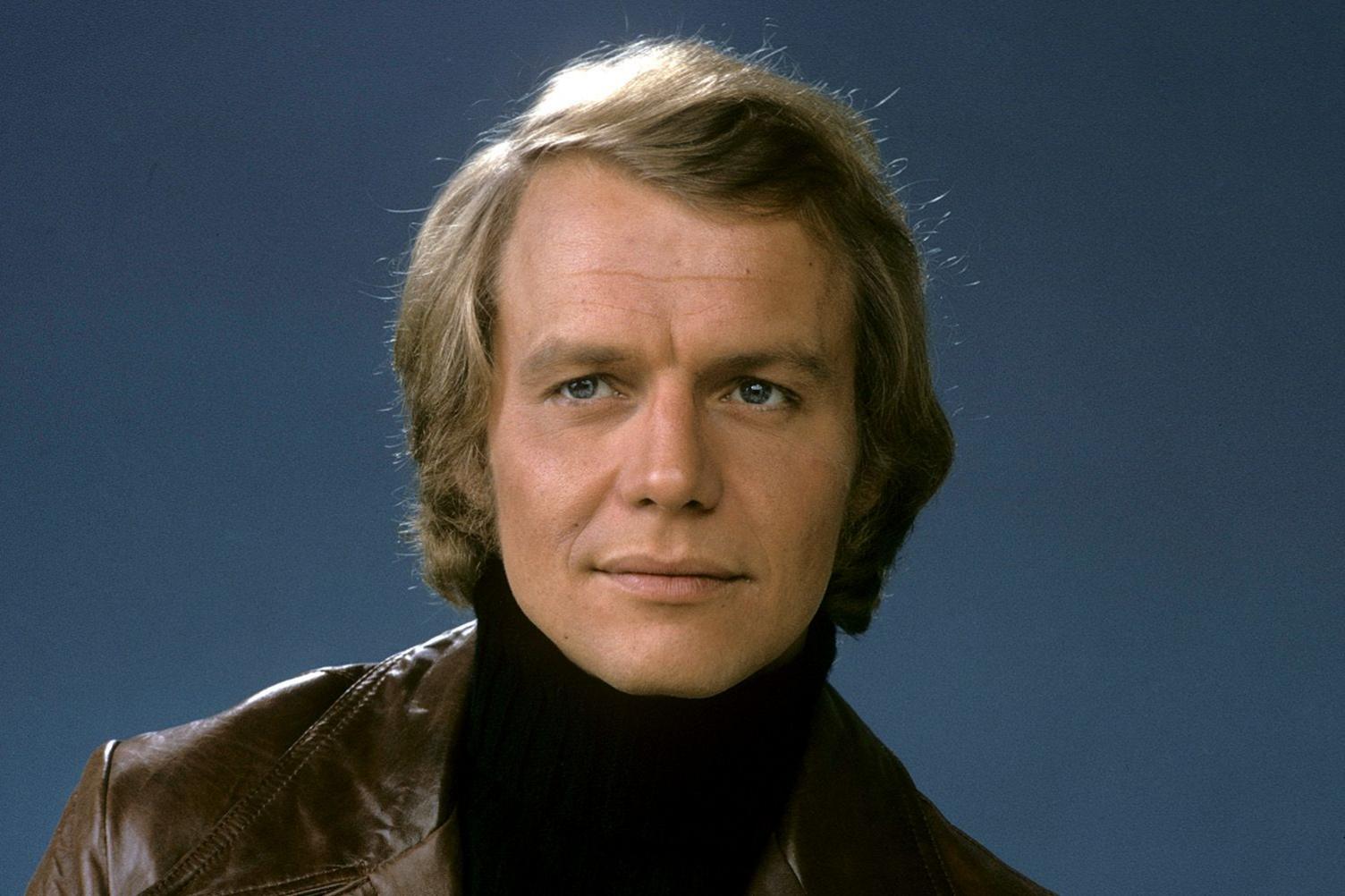 David Soul from his "Hutch" days dressed in a brown leather jacket and black roll neck