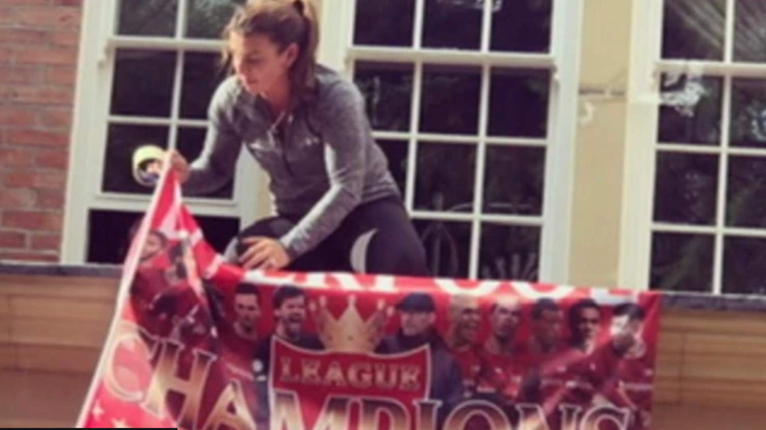Coleen Rooney hanging Liverpool flags up at their house