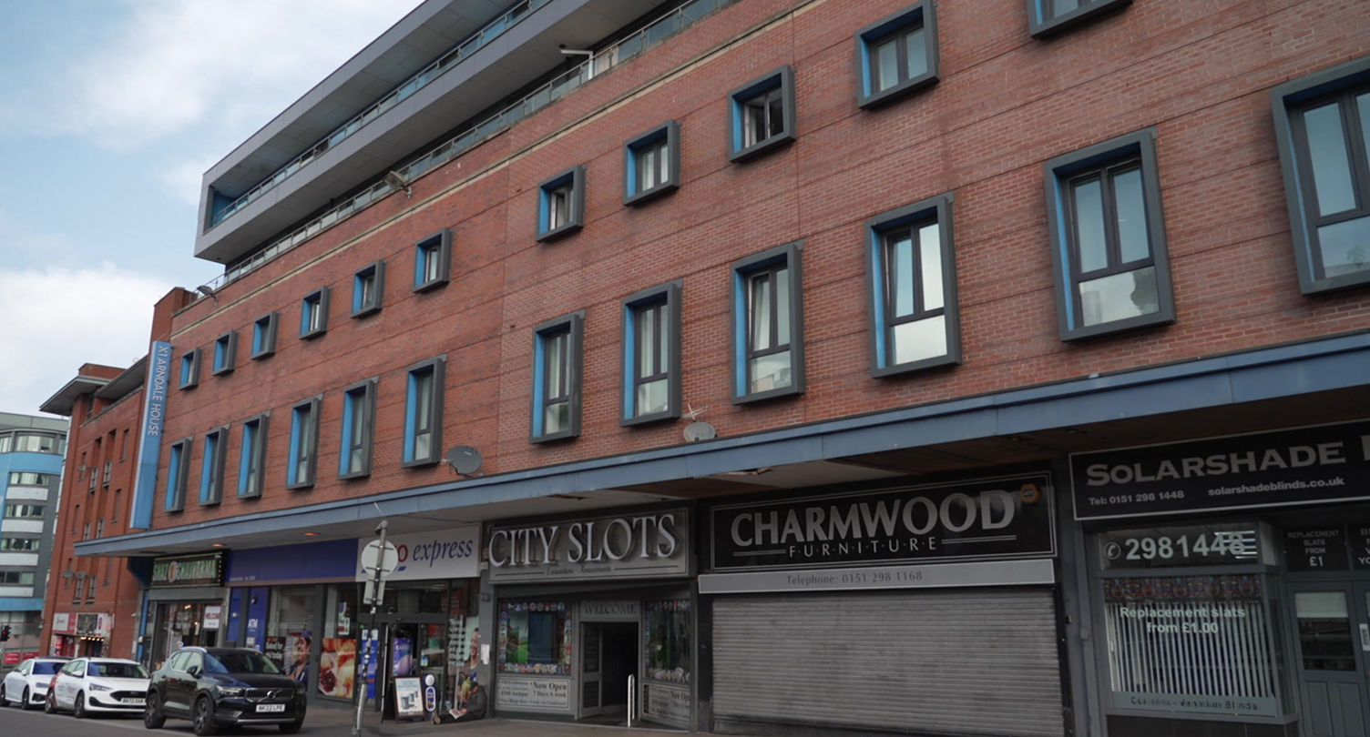 The exterior of Arndale House, a four-storey student accommodation block sitting on top of a parade of shops in Liverpool's London Road.