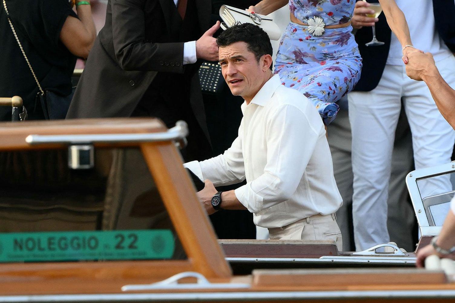 British actor Orlando Bloom wearing a white shirt and cream-coloured trousers in Venice, Italy, for the wedding of Jeff Bezos and Lauren Sanchez.
