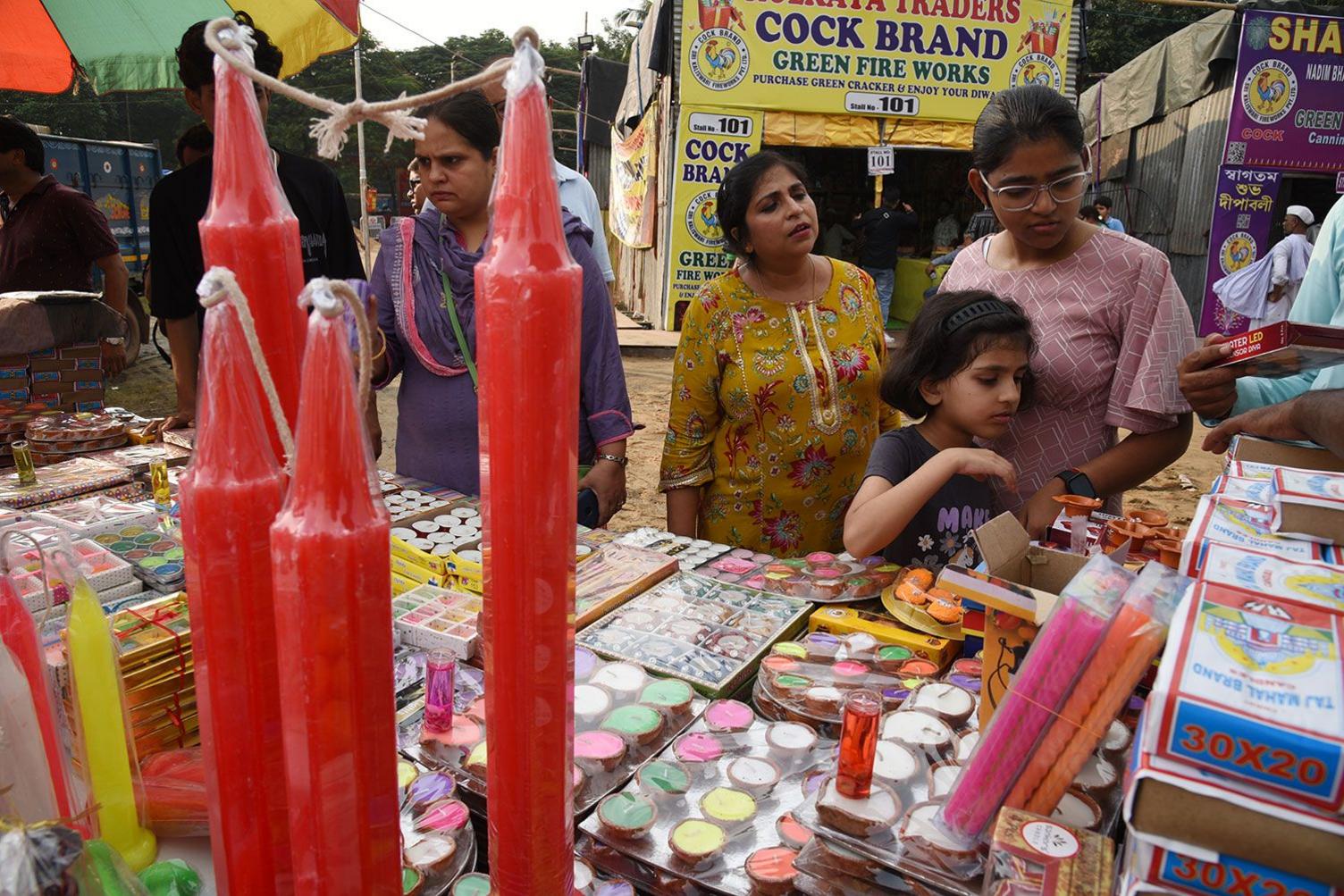 People shop for candles and earthen lamps ahead of Diwali in Kolkata, on October 29, 2024