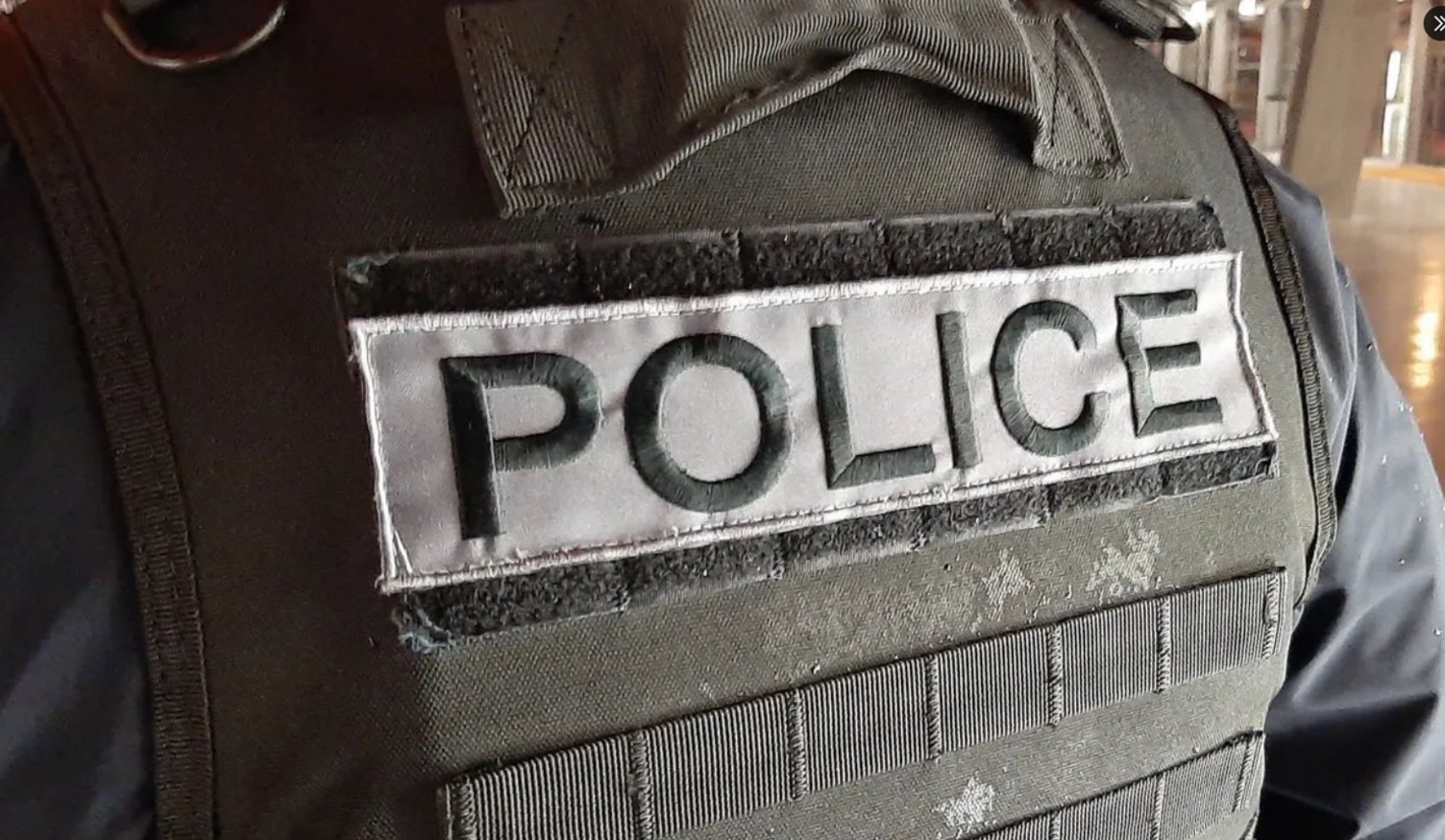 Close-up of a  Vienne Police officer's bullet-proof vest featuring a label reading 'Police'