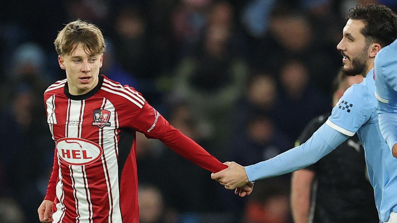Manchester City's France midfielder Rayan Cherki congratulates Birch on his goal as he runs back to the centre circle