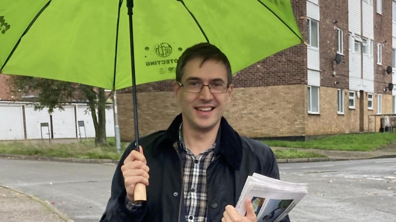 Green Party co-leader, Adrian Ramsey with umbrella and leaflets